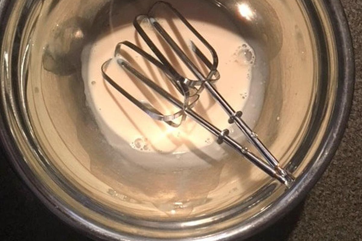 evaporated milk in bowl with beaters