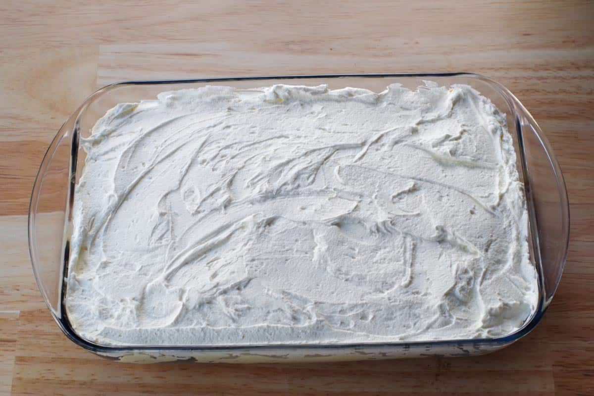 whipped cream layer spread evenly over pudding layer