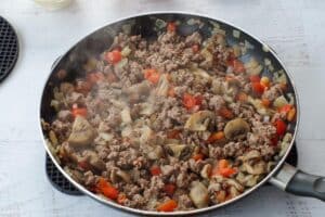 browned ground beef with vegetables in skillet