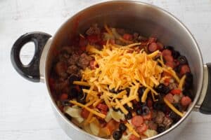 ground beef mixture in pot with other ingredients (cheese etc0