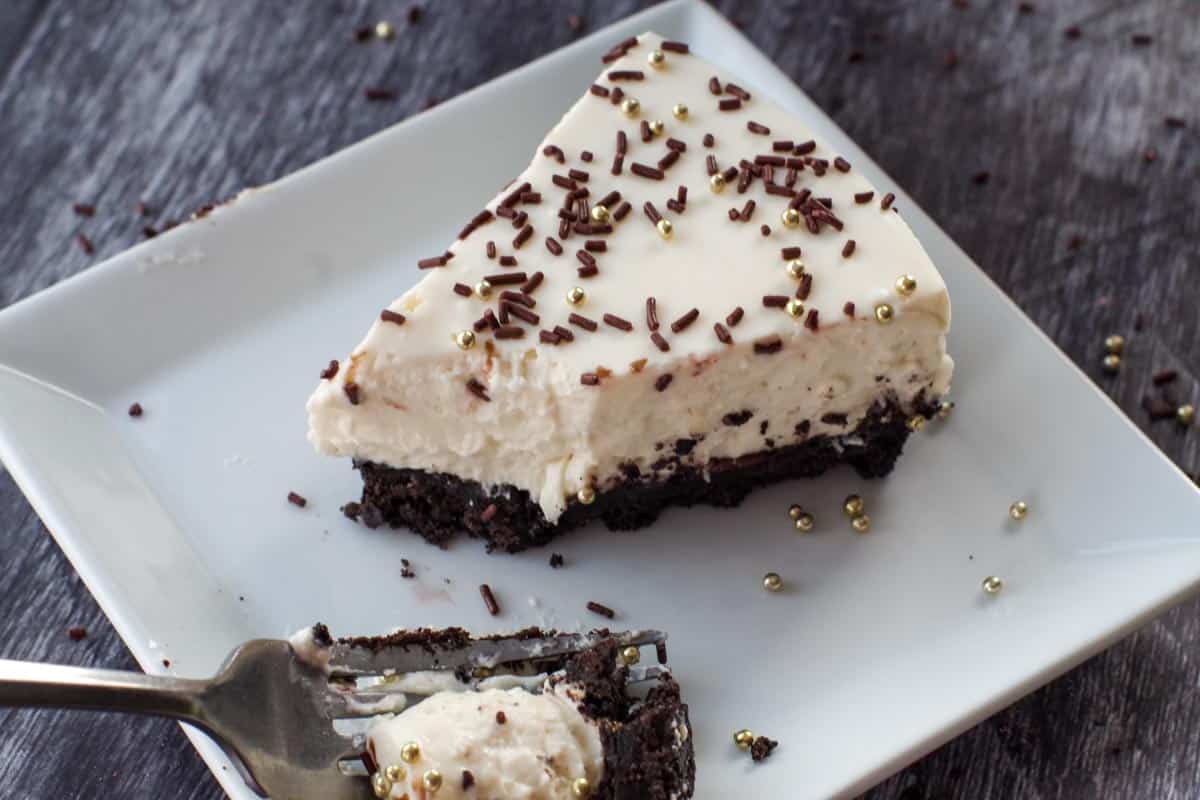 baileys no bake cheesecake being eaten with a fork, on a white plate with