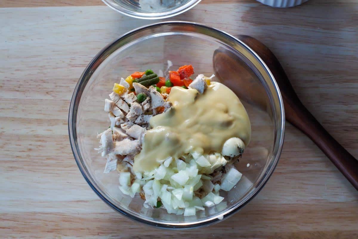 Ingredients in chicken pot pie in a glass bowl