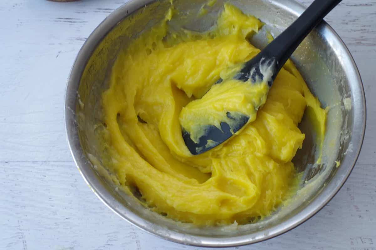 yellow food coloring mixed in, in stainless steel bowl