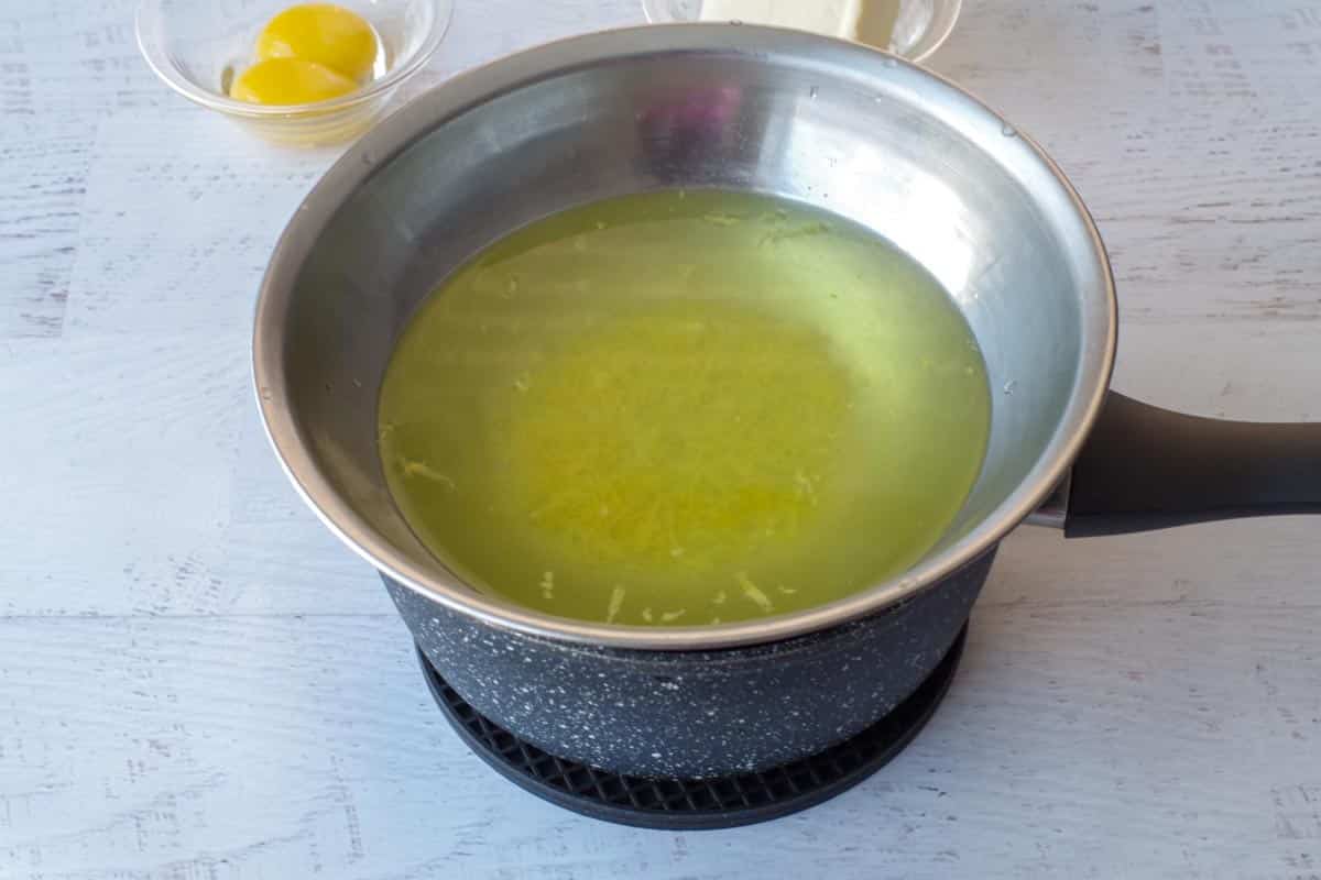 lemon zest with water in makeshift double boiler