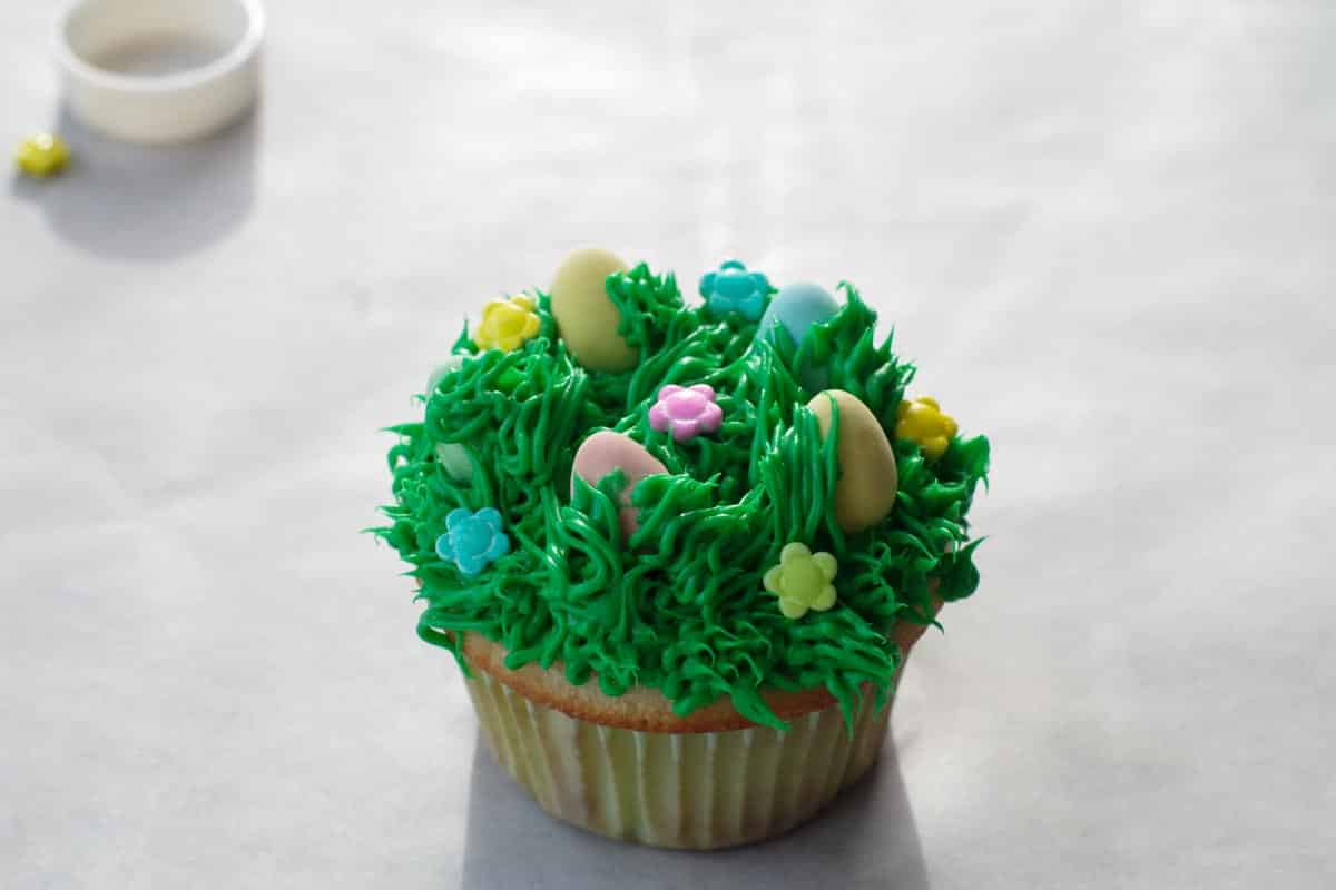 candy flowers added to top of cupcakes
