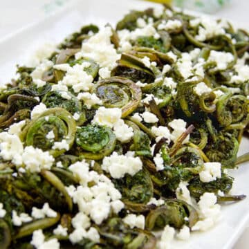 Roasted Fiddlehead Ferns on a white platter