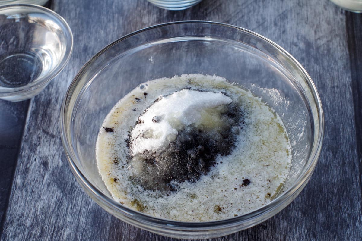 cocoa, melted butter and Oreo baking crumbs in a glass bowl