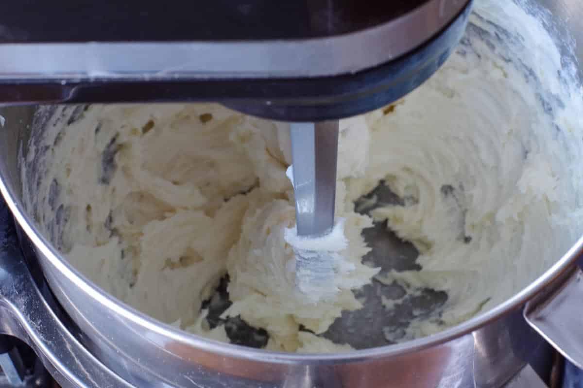 cream cheese and sugar mixed together in stand mixer