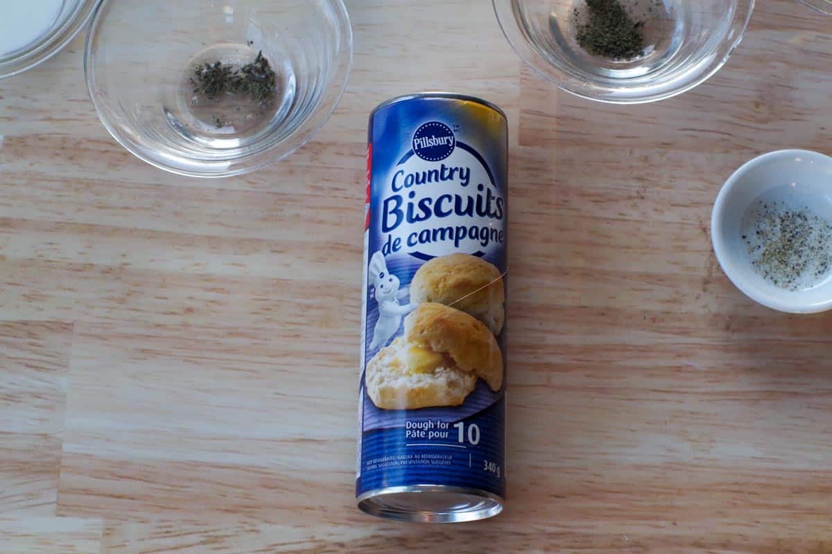 tube of country biscuits with jars of other ingredients in dishes