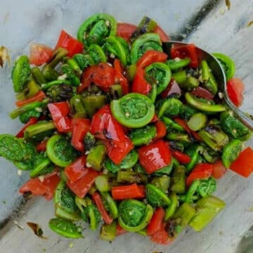 all dressed fiddleheads in a glass bowl