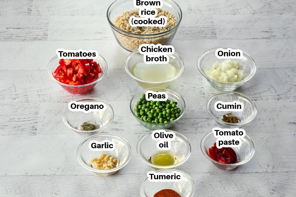 ingredients in brown spanish rice, in glass bowls, labelled