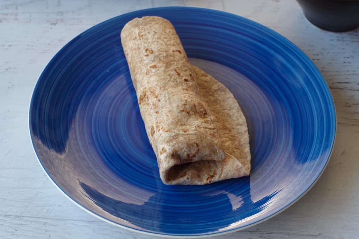 tortilla wrapped up on a blue plate