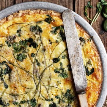 whole fiddlehead quiche with knife on top