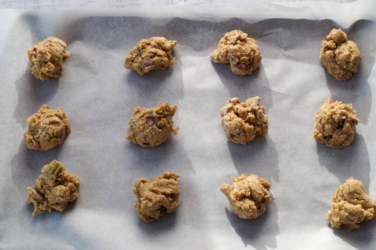 cookie dough in heaping tablespoons on a parchment lined baking sheet