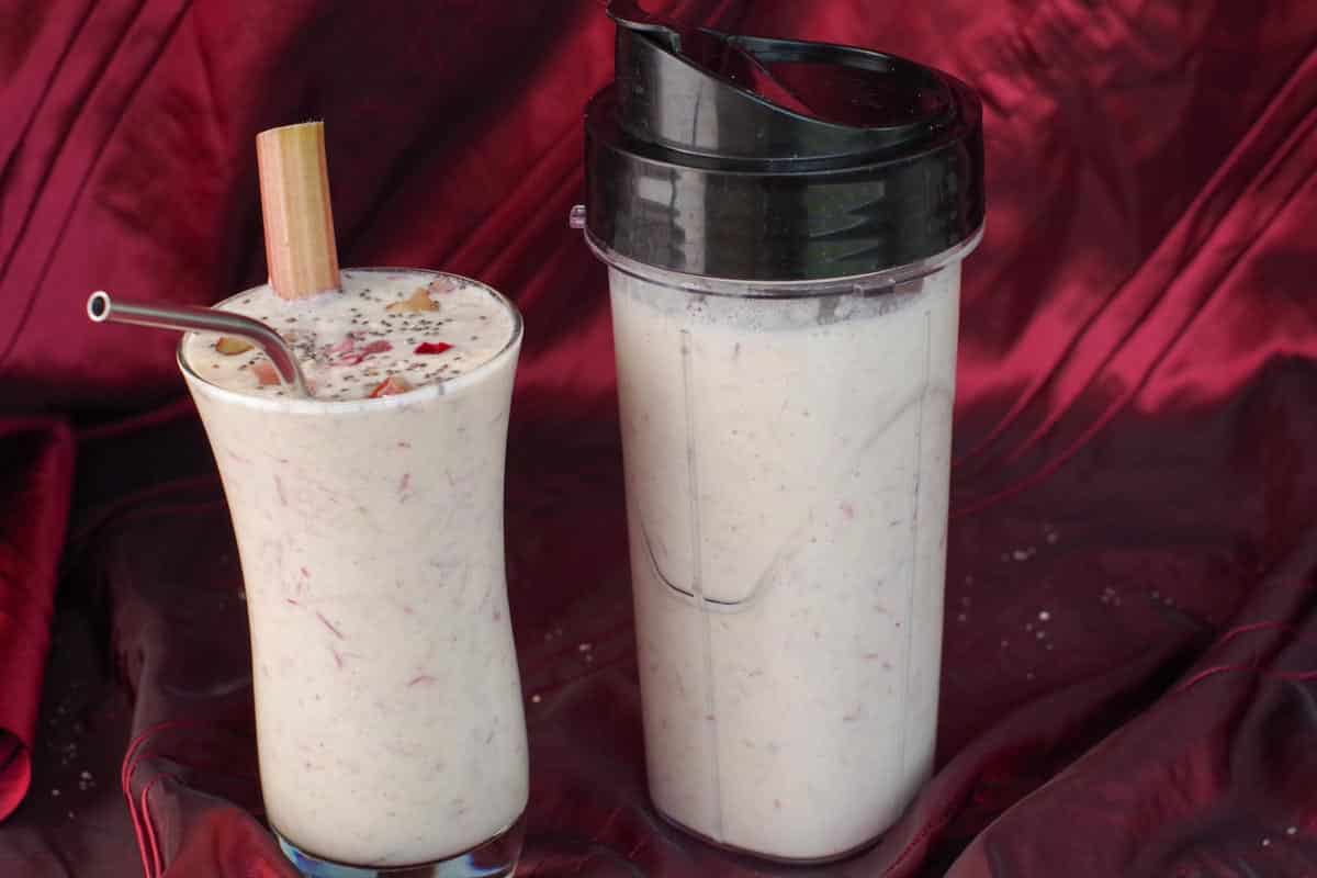 rhubarb smoothie beside a storage container of rhubarb smoothie