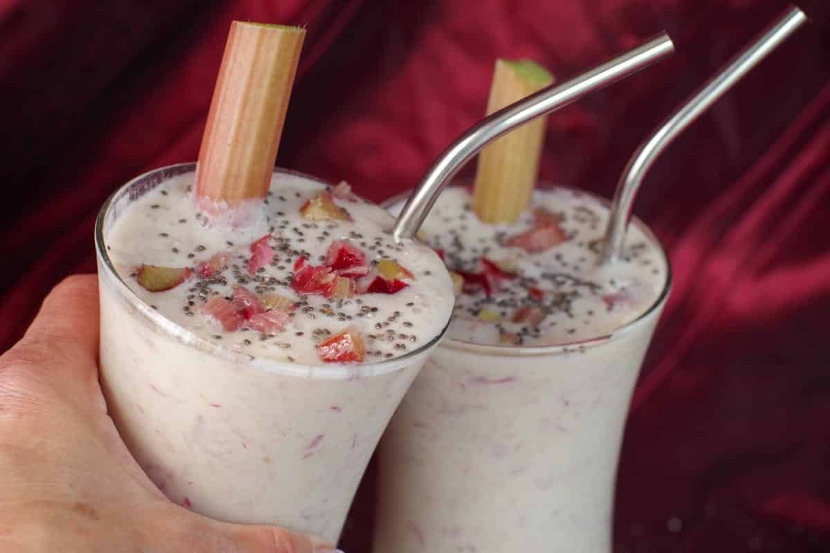 2 rhubarb smoothies clinking glasses