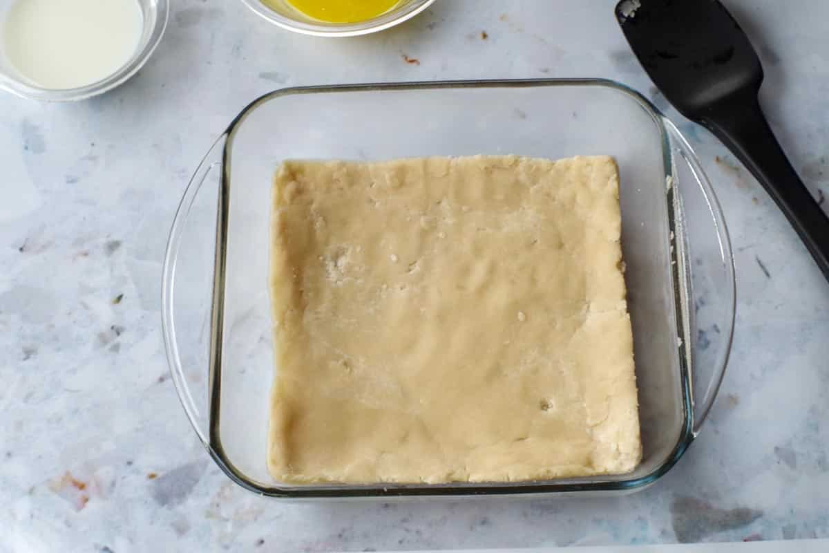 shortbread base pressed into the bottom of a 8x8 glass pan