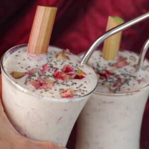 2 rhubarb smoothies clinking glasses