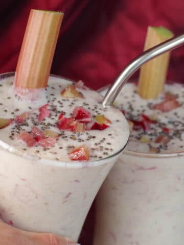 2 rhubarb smoothies clinking glasses