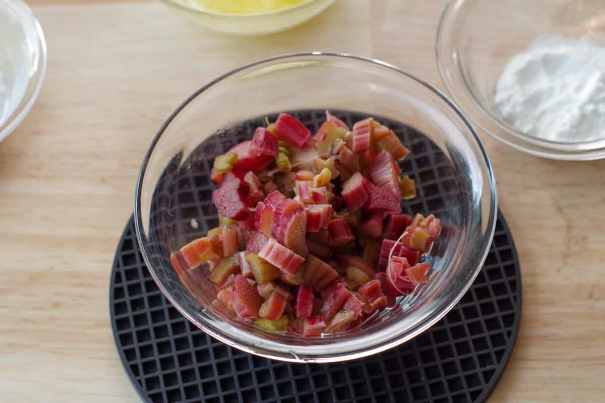 cooked rhubarb in glass bowl on black trivet