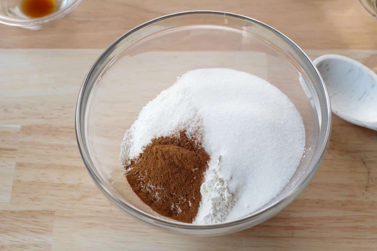 flour, sugar, cinnamon, coconut, baking powder and salt added to a glass mixing bowl