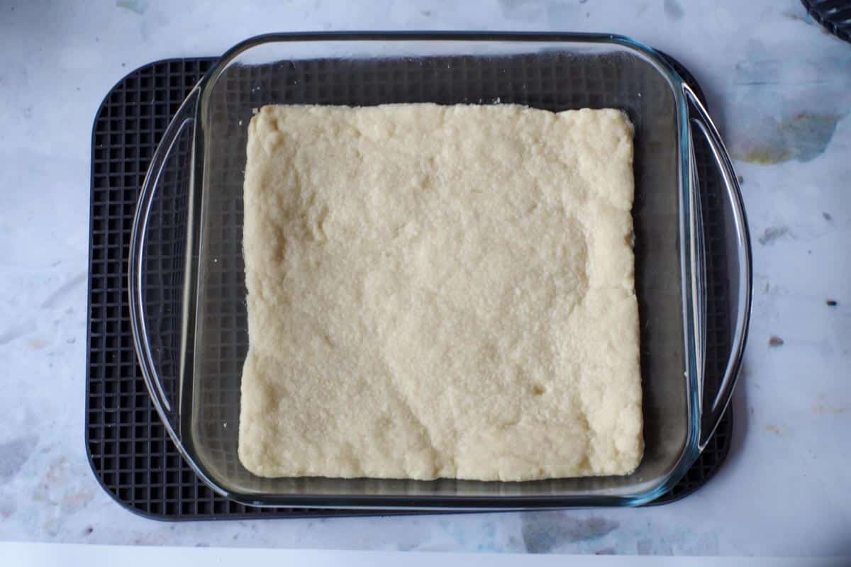 base of rhubarb meringue torte, baked, in a glass pan on a trivet