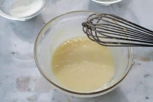 egg yolks flour and sugar being whisked together