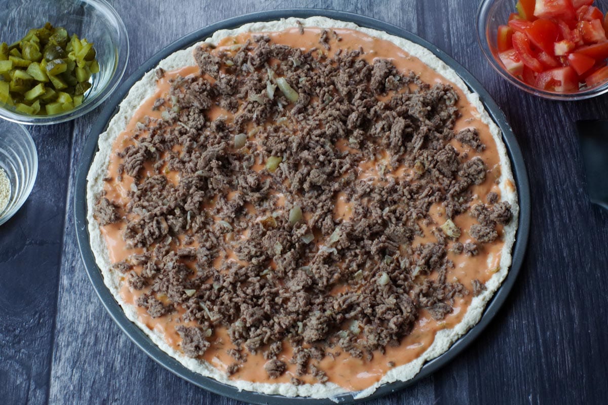 ground beef spread over pizza sauce
