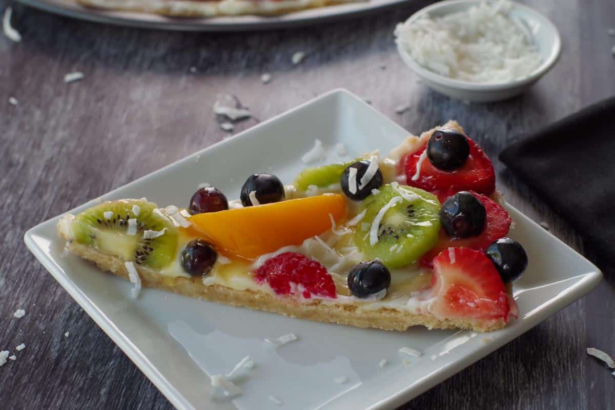 piece of fruit pizza on a white plate