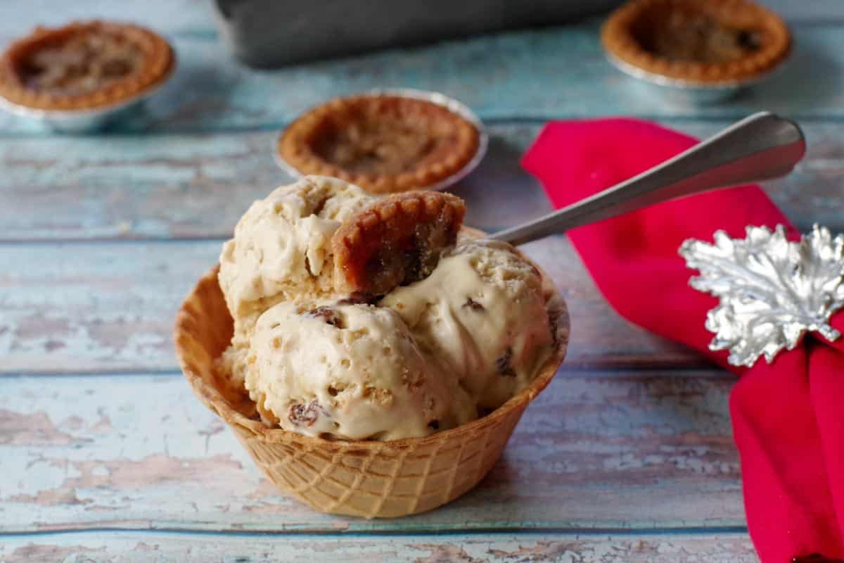 butter tart ice cream in a waffle bowl with a red napkin on the side