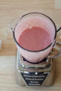 ingredients in strawberry yogurt popsicles blended together in blender