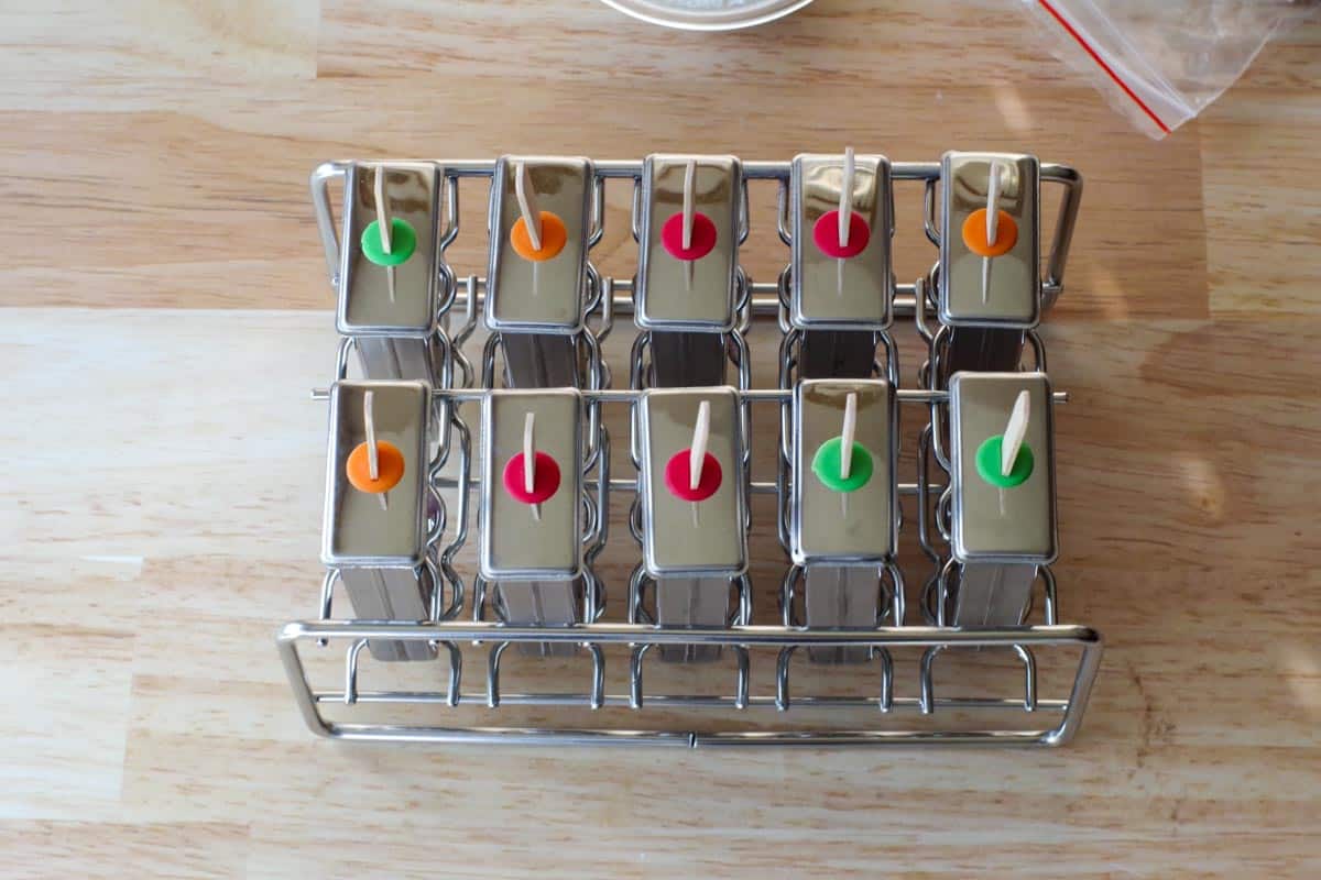 popsicle molds with tops and sticks, ready to be frozen