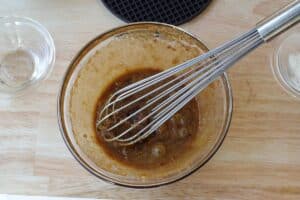 egg and brown sugar whisked together in glass bowl