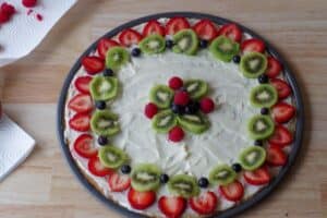 fruit pizza with outer edge decorated with fruit