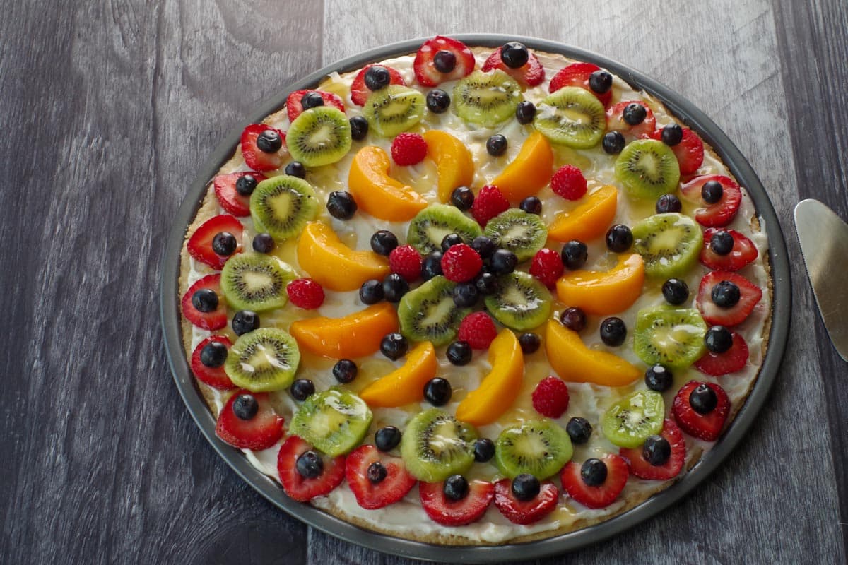 fruit pizza with glaze drizzled on top