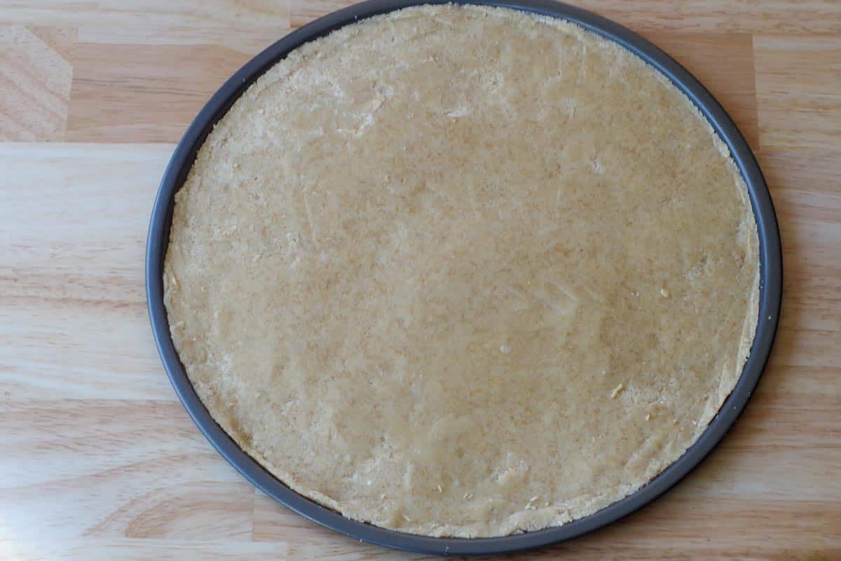 shortbread crust dough rolled onto pizza pan