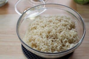 Drained ramen noodles in a large glass bowl