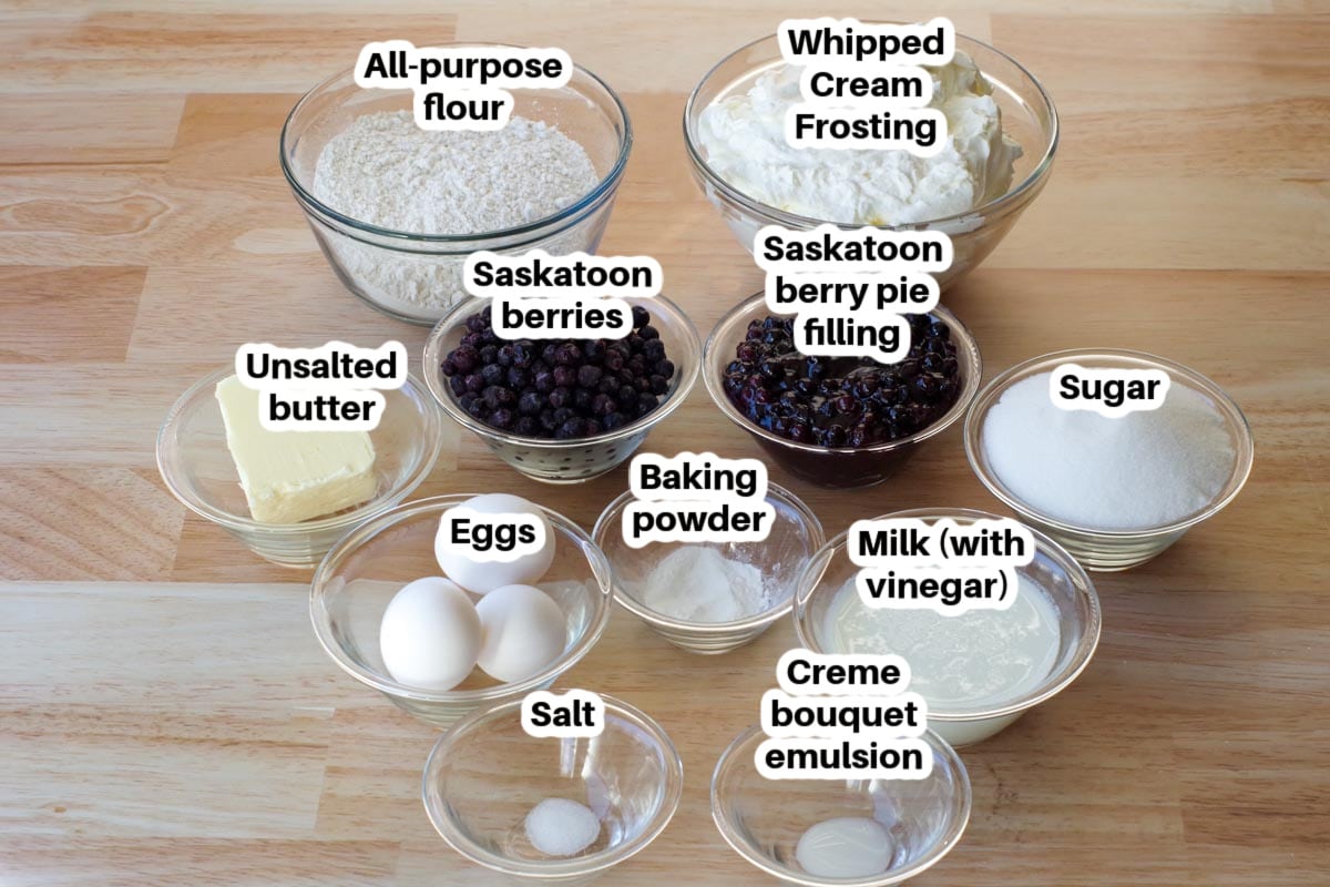 Ingredients in Saskatoon berry layer cake in glass dishes, labelled.