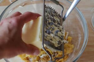 butter being cut in with grater