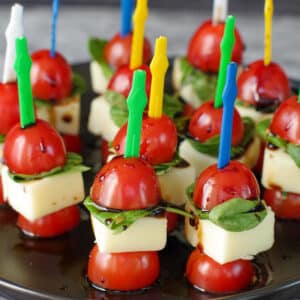 caprese bites on a black platter