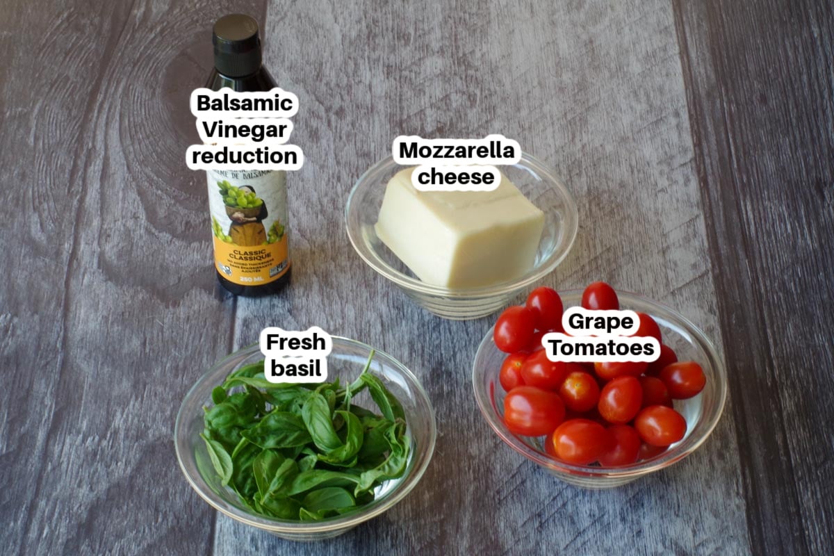 caprese salad stick ingredients in glass bowls, labelled