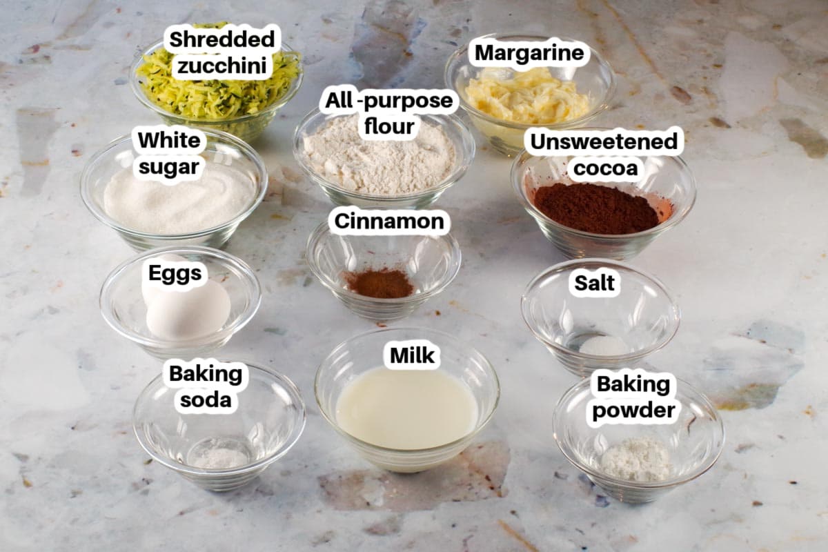 ingredients in chocolate blender zucchini bread in glass bowls, labelled