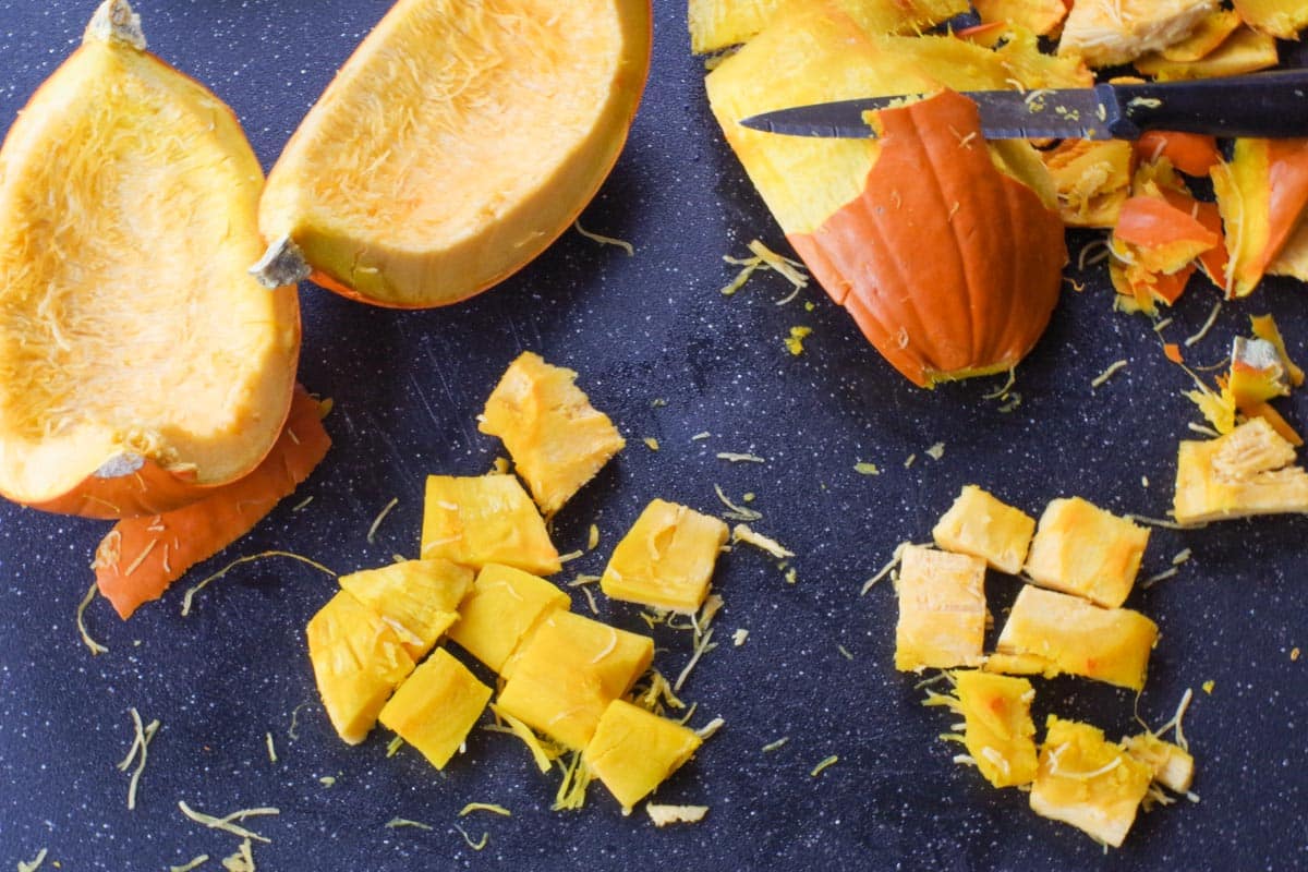 pumpkin being peeled and cut into bite sized pieces