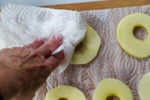 apples being patted dry with paper towel