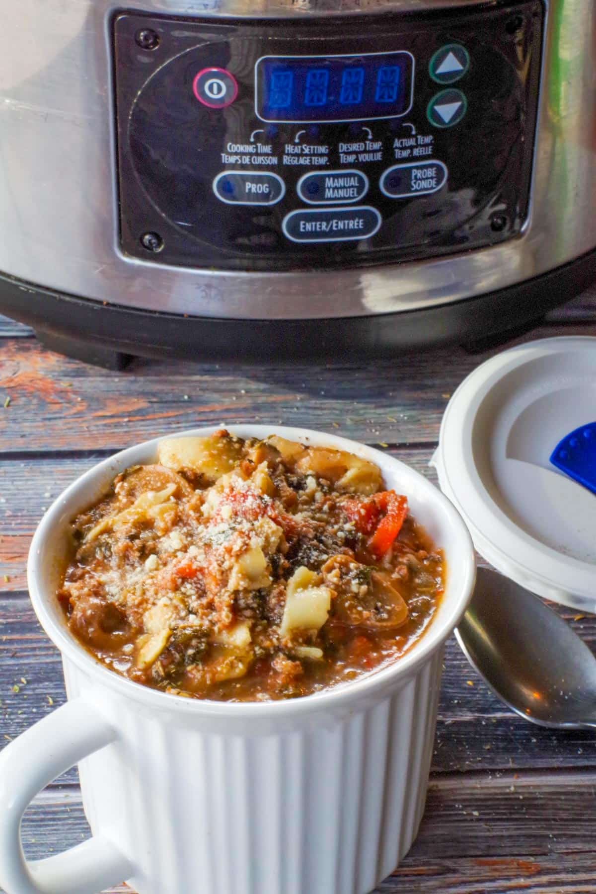 lasagna soup in meal mug with lid and slow cooker in background