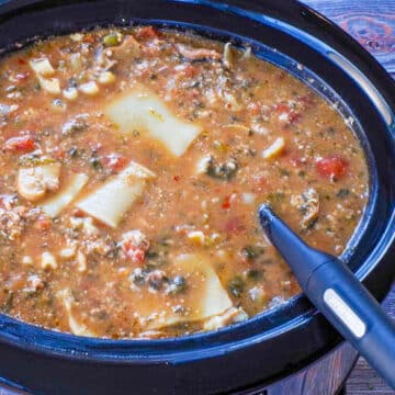lasagna soup in slow cooker with ladle