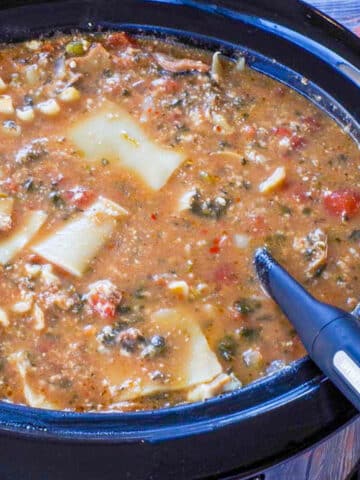 lasagna soup in slow cooker with ladle