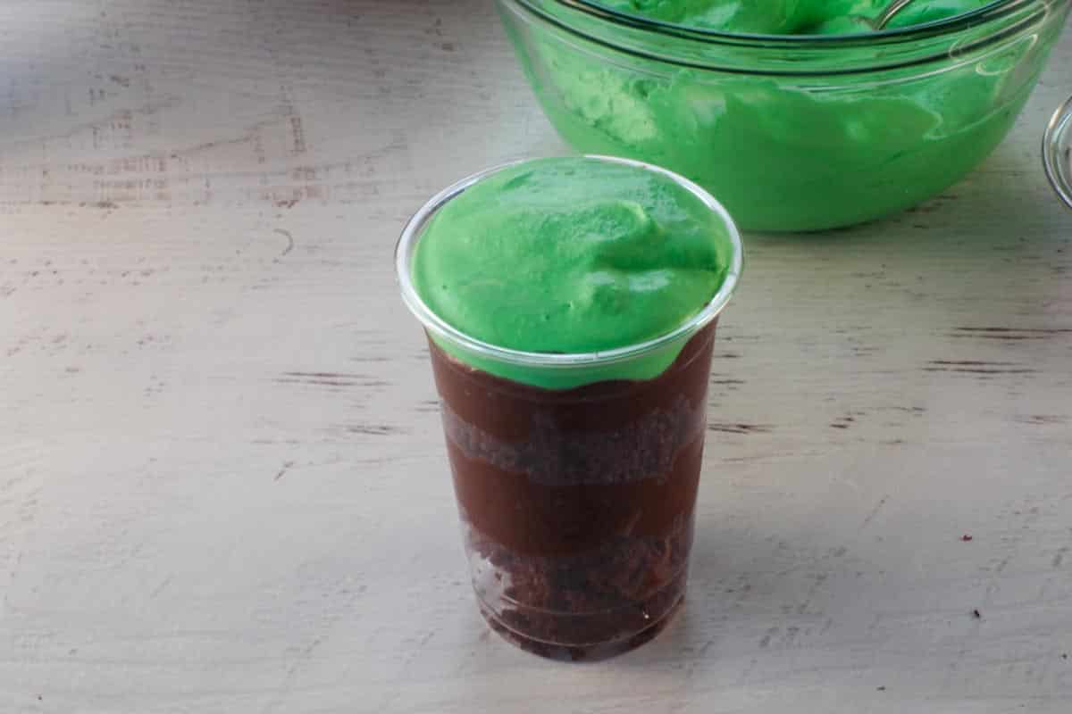 layer of green whipped cream added on top of final pudding layer