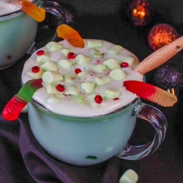 Halloween hot chocolate in a clear mug with a black background