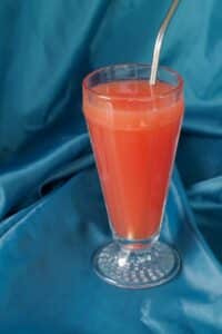 grenadine added to glass and stirred with straw
